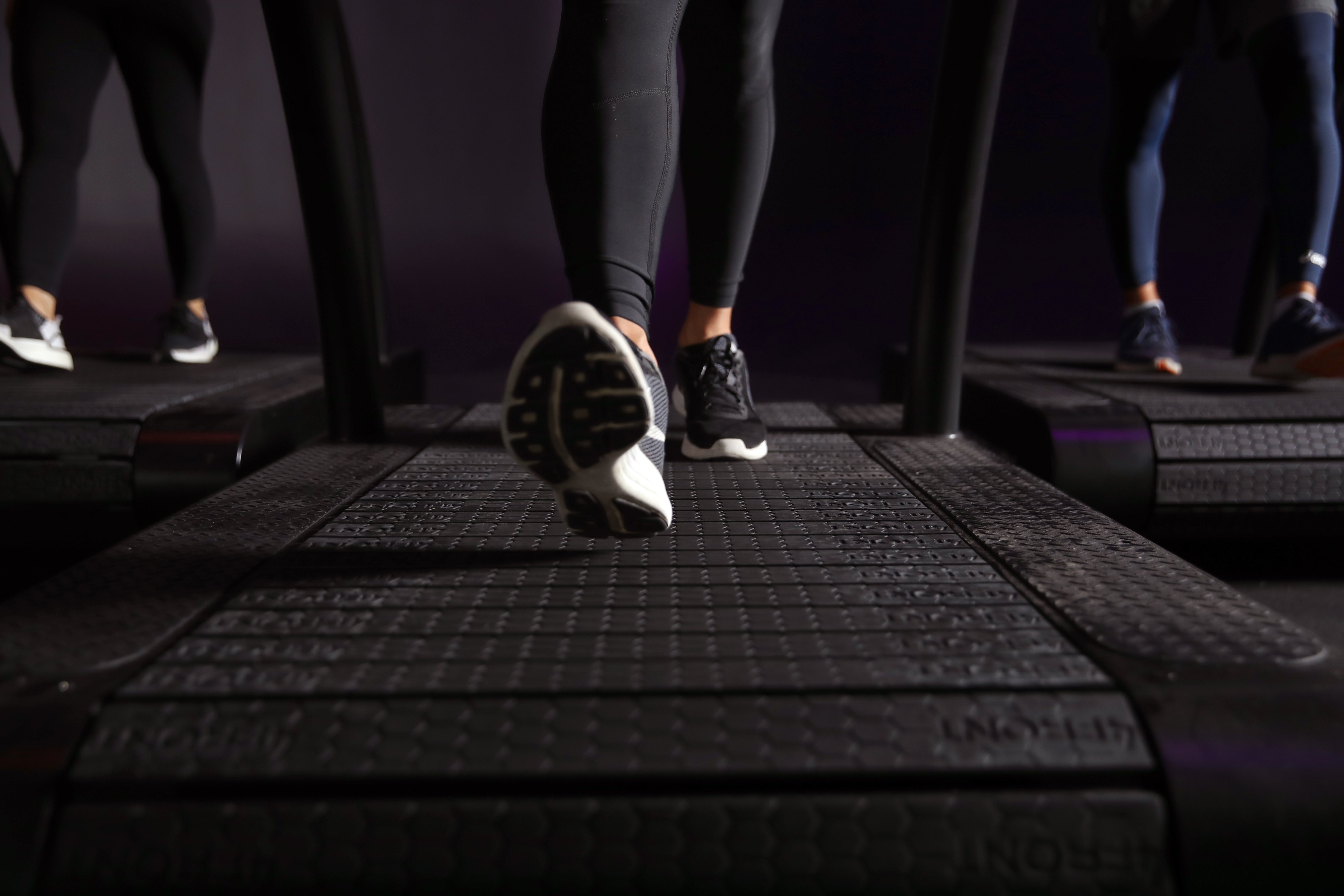 Three people running on treadmills